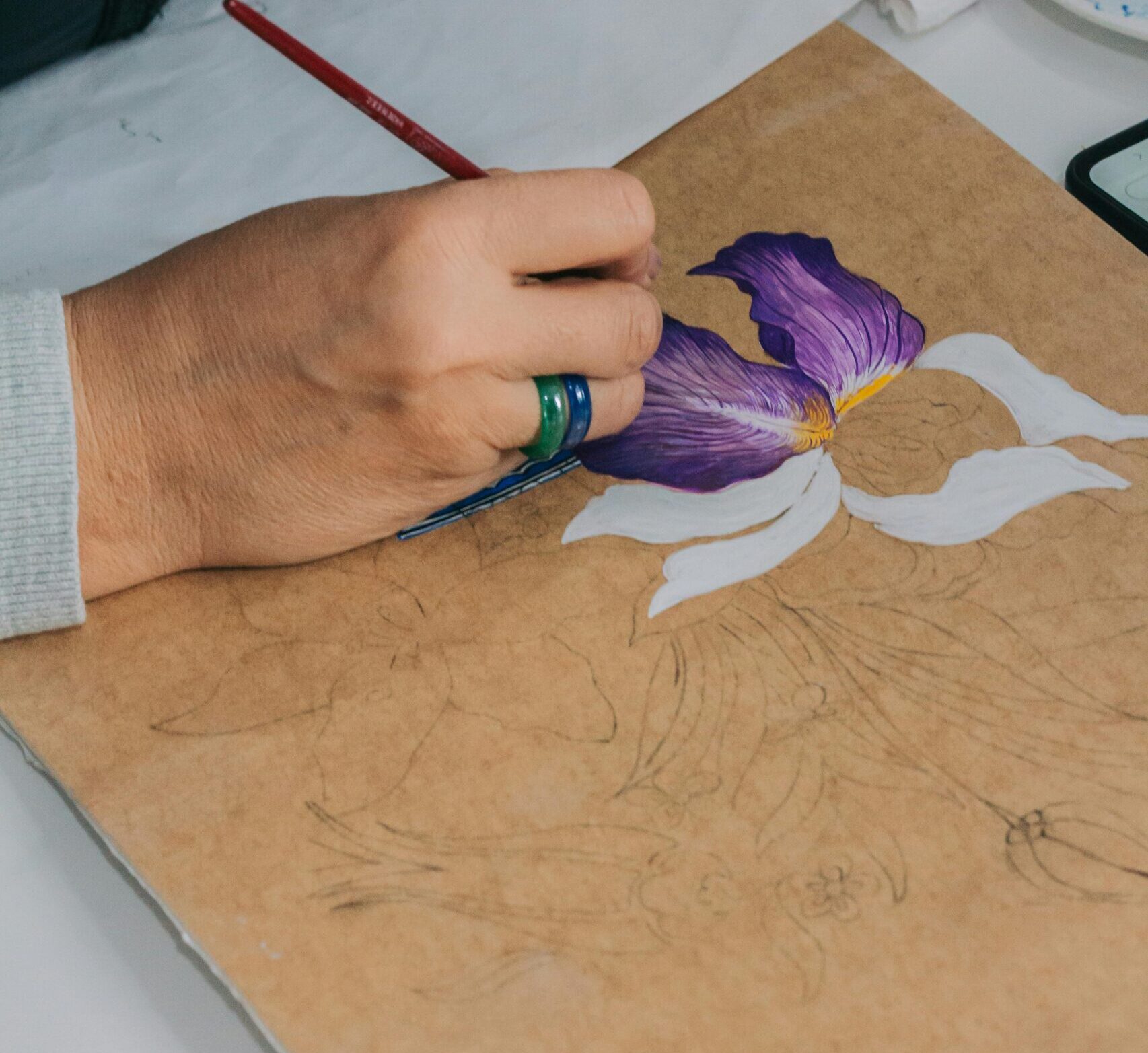 pexelsphoto2986691629866916 Miriam Baranov Art An artists hand painting a purple iris flower on canvas detailed brush technique